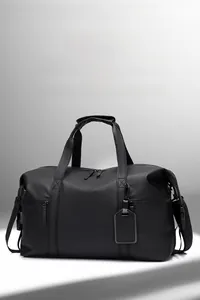 Detailed view of black waterproof nylon fitness travel bag with handles and strap
