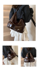 Detail of dark brown glossy tote bag showing convertible straps and pocket accents