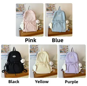 Detail view of five minimalist school backpacks in pink, blue, black, yellow, and purple colors