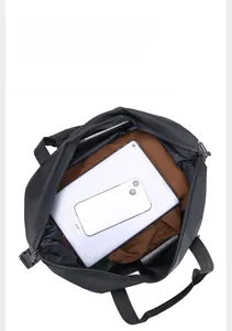 Top view of large capacity travel bag interior showing organized storage for clothes and tablet