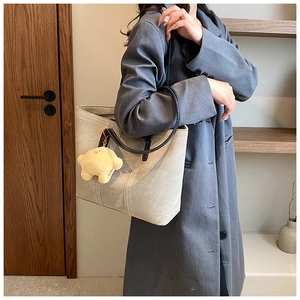 Minimalist grey tote bag with white topstitching and cute yellow star plush charm