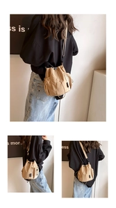 Detail of khaki drawstring bucket bag with mesh side pockets and adjustable strap