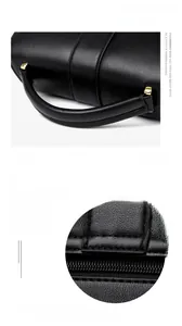 Detail of premium black cowhide leather texture and sturdy reinforced hand straps on bag