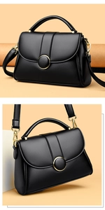 Close-up of black lychee texture leather handbag with gold buckle and hardware details