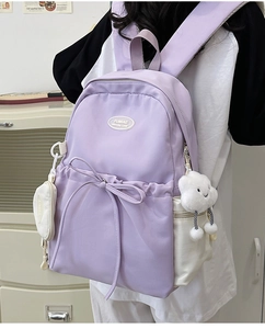 Detail of light purple nylon backpack with drawstring bow and cloud plush charm