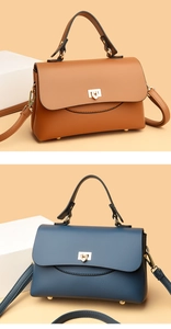 Close-up of litchi grain leather handbags with golden turn-lock and adjustable straps