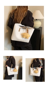 Detail of white PU leather tote bag with brown straps and cute yellow star pendant
