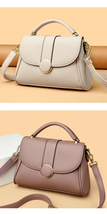 Close-up of elegant cream and pink handbags with circular metal snap and litchi texture