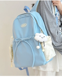 Close-up of the light blue backpack side view with cute cloud pendant and drawstring detail