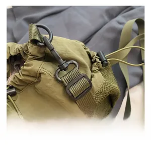 Close-up of premium black metal swivel hook and nylon strap on army green bucket bag