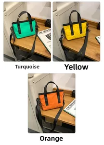 Detailed view of lightweight mini tote bags in teal, yellow, and orange with black straps