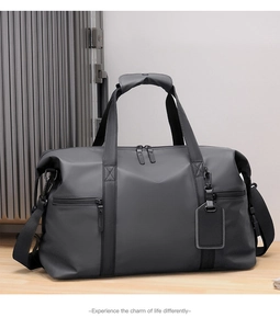 Detailed shot of dark charcoal large travel bag with waterproof texture on wooden surface