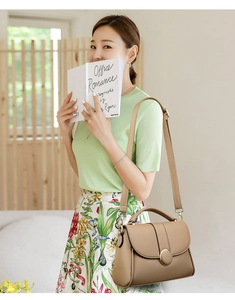 Khaki leather handbag styled with floral skirt and green top for a casual commute look