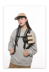 Detail of khaki tactical chest bag with reflective straps and durable molle webbing system