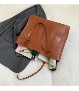 Brown tote bag interior showing large capacity for books and daily essentials