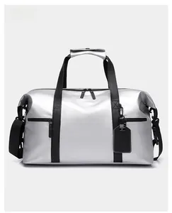 Close-up of metallic silver travel bag with waterproof finish and black handles