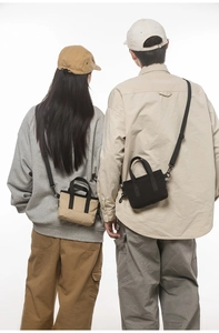 Rear view of mini crossbody bags in black and khaki shown on models with nylon straps
