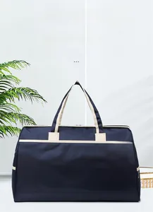 Detail of navy blue water-resistant travel bag with SPORT logo and cream handles