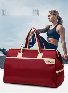 Macro detail of red nylon travel bag featuring khaki handles and Sport lettering logo
