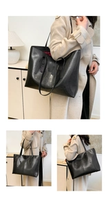 Macro detail of large black leather tote bag with contrasting red lining and long straps