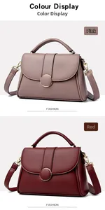 Detail of pink and red textured leather handbags with elegant golden metal buckles