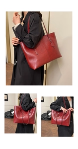 Macro detail of high-capacity burgundy leather tote bag with fine texture and dual straps
