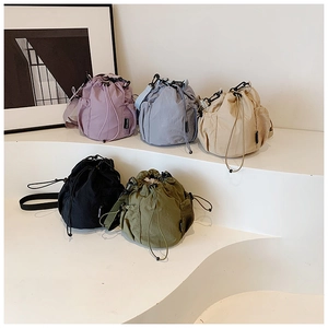 Detailed display of colorful nylon drawstring bucket bags with side mesh pockets in five colors