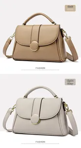 Detail of khaki and light grey leather handbags with round gold buckles and soft texture