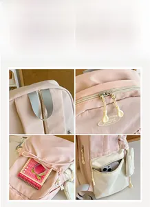 Detailed close-up of pink backpack showing reinforced handle and rubber logo zippers