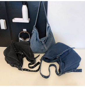 Three denim crossbody bags in black, light blue, and dark blue with metal eyelet straps