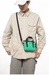 Mini green nylon crossbody bag shown on a male model for casual sporty style