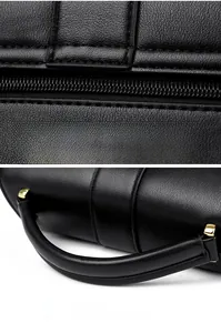 Macro detail of black lychee leather bag with smooth zipper and golden hardware