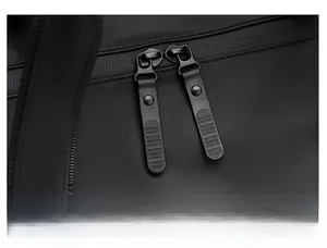 Detail of the durable dual-zipper closure on the waterproof black travel bag with easy-grip pulls