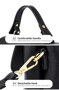 Detail of lychee textured black leather handbag with golden hooks and comfortable handle
