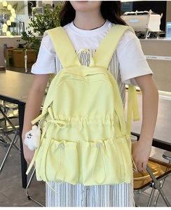 Pale yellow waterproof nylon school backpack with cute bear pendant and drawstring pockets