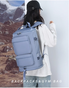 Vue arrière d'un mannequin portant le sac à dos de sport bleu brume dans un décor naturel
