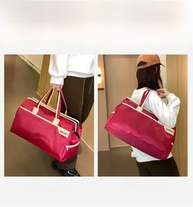 Detailed view of red large capacity travel bag with double handles and sport printing