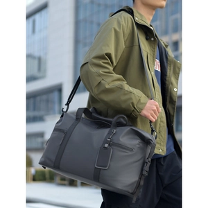 Men's large capacity grey travel bag with water-resistant fabric and shoulder strap