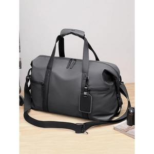 Large capacity waterproof dark grey travel bag with shoulder strap on wooden table