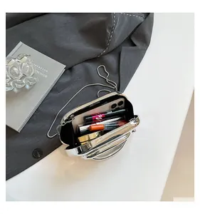 Interior view of silver mirror evening clutch bag showing space for phone and makeup