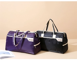 Detail view of large sport travel bags in black and purple with reinforced handles