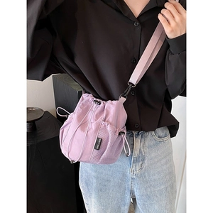 Light purple nylon drawstring bucket bag with adjustable wide shoulder strap for women