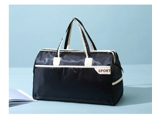 Close-up of a blue waterproof travel bag with Sport logo and white trim detail