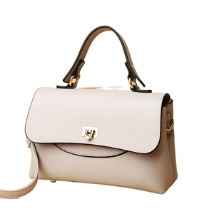 Chic cream-white pebbled leather handbag with gold heart lock and crossbody strap