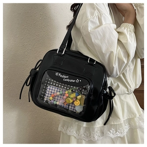 Detail of black ita bag with transparent window showing beads and star pattern