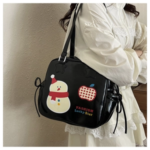 Detail of black glossy faux leather tote bag with cute cartoon prints and bow drawstring
