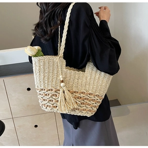 Detalle del bolso tote boho tejido con patrones geométricos y borla de flecos