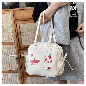 Close-up of cute snowman illustration and bow detail on the white PU leather tote bag