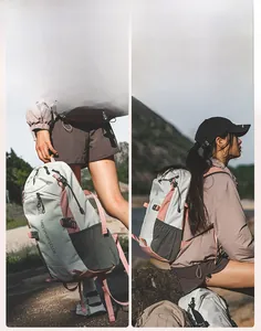 Close-up of a versatile light grey hiking backpack with pink straps in an outdoor setting