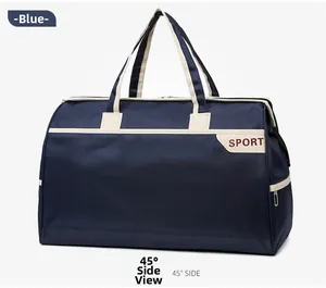 Detail view of large blue travel bag with off-white handles and red SPORT text logo
